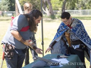 Human warrior Fenix and Elven bard Rala play a game of dice at a Southern Isles LARP Lore Event.