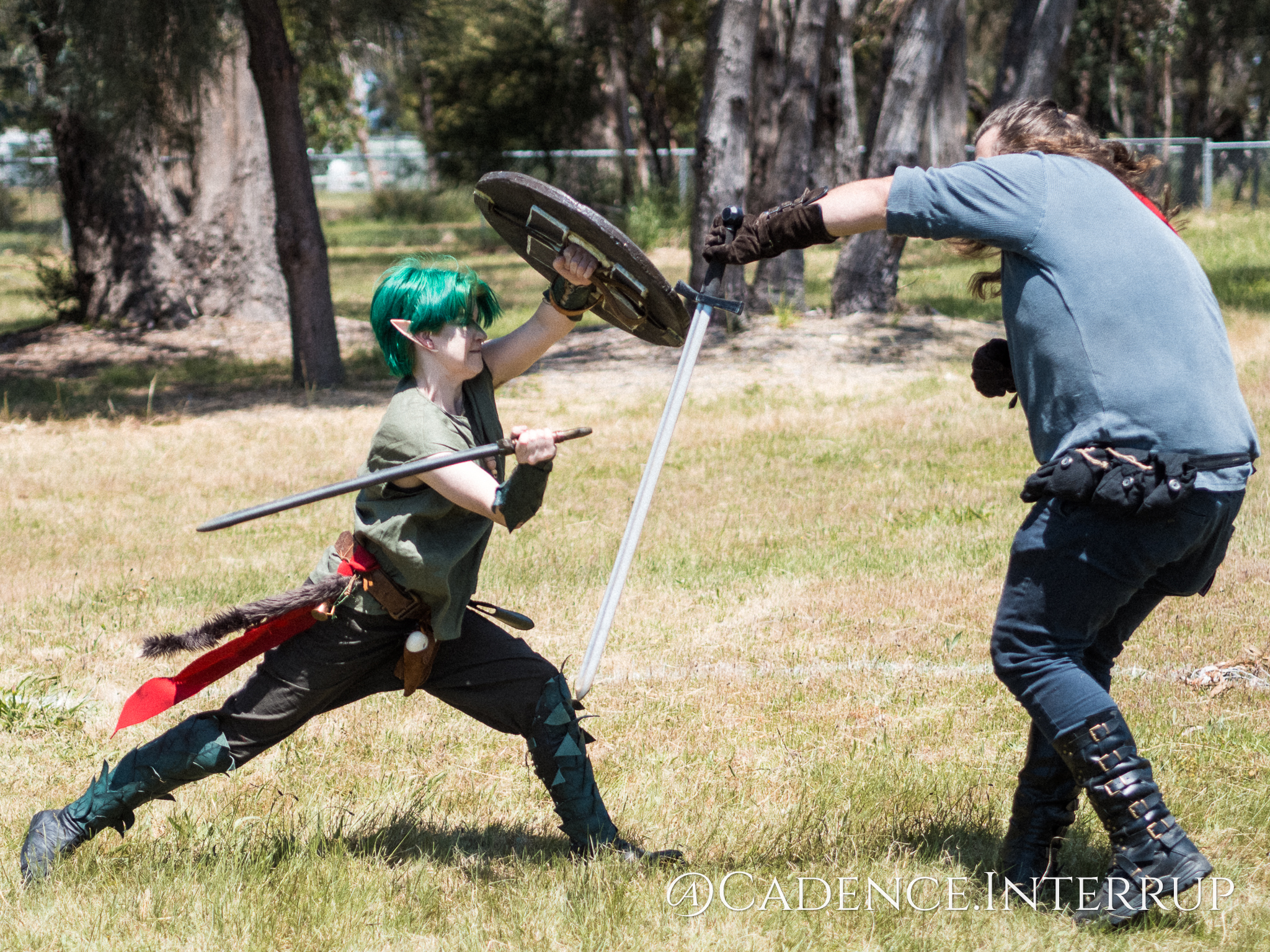 Moss, an elven warrior lunges toward Fenix in sword combat.